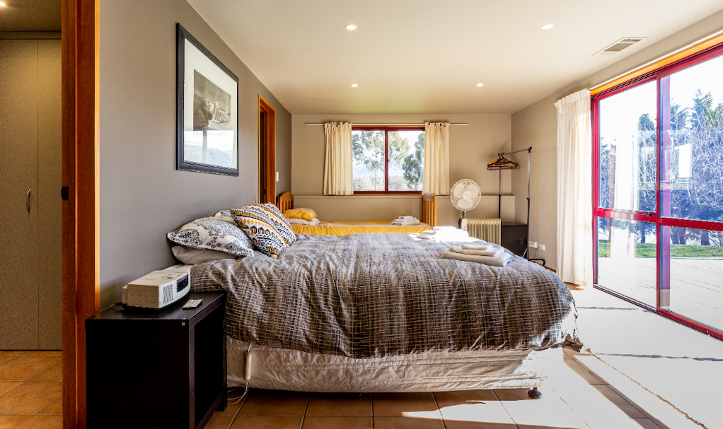 Spacious bedroom with king bed and deck access