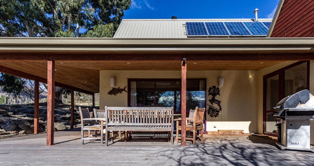 Covered outdoor dining area with BBQ